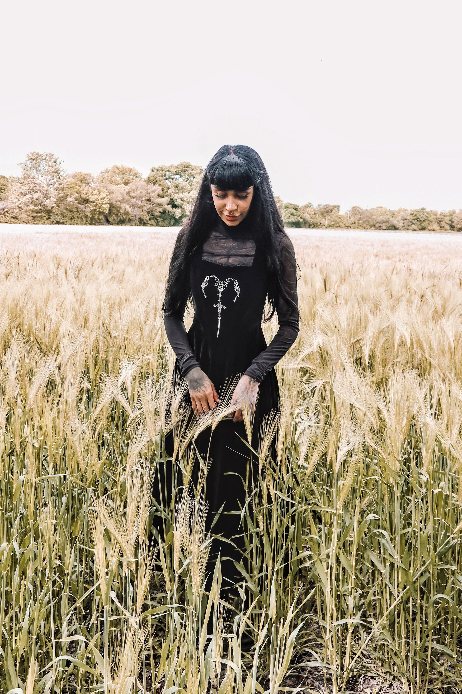 Close-up of Dark In Love Lux Black Velvet Maxi Dress displaying luxurious velvet fabric and detailed horn embroidery, ideal for a sophisticated look.