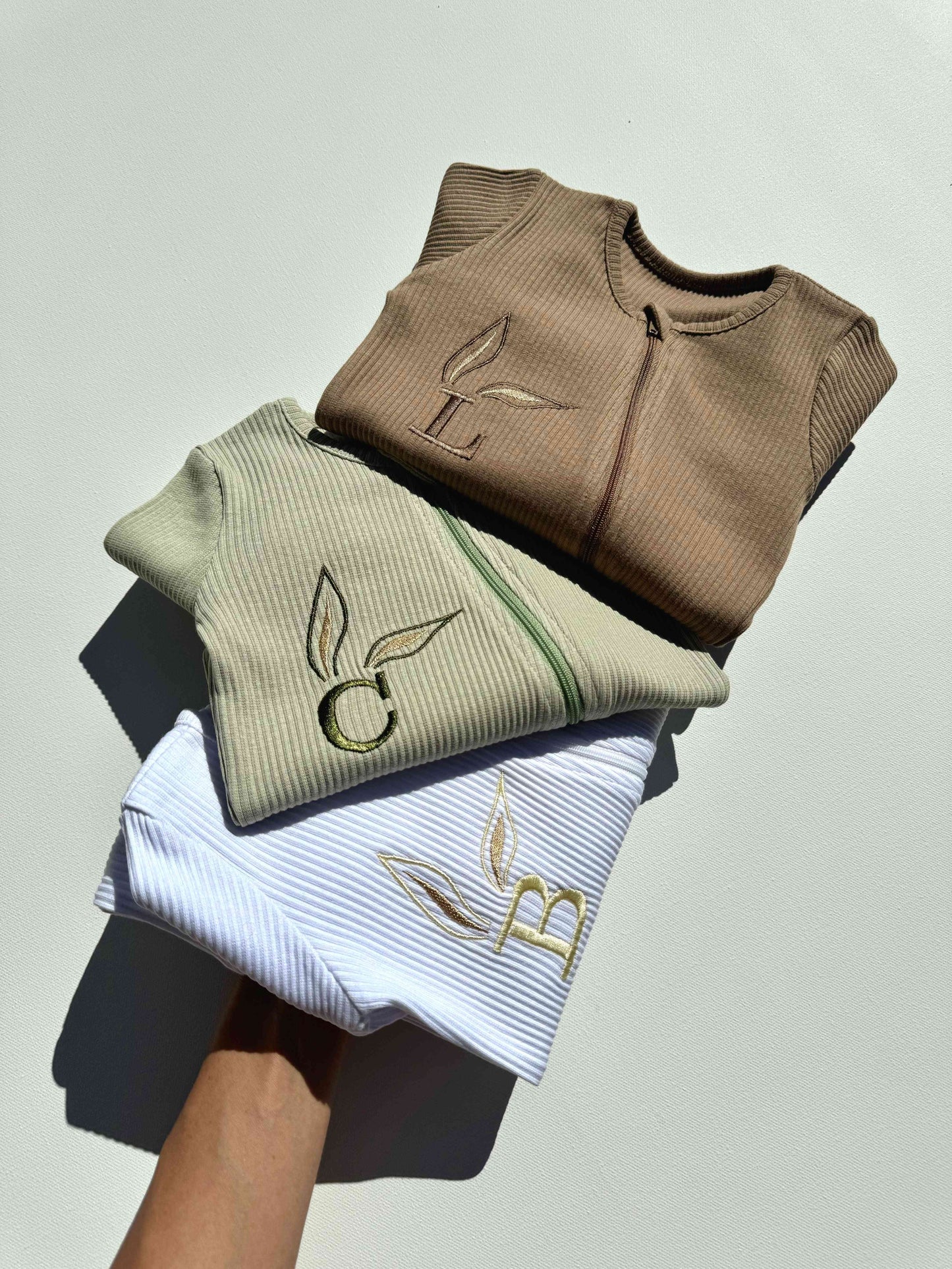 Luxurious personalised Easter baby zip romper from DreamBuy, featuring elegant embroidered initials and leaf detailing for spring celebrations.