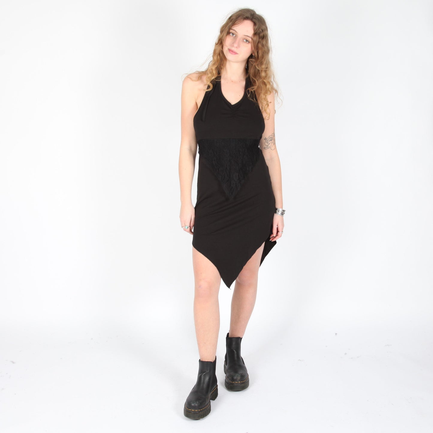 Elegant black halter neck dress featuring intricate lace detailing and a stylish pointed hem, perfect for casual or chic occasions.