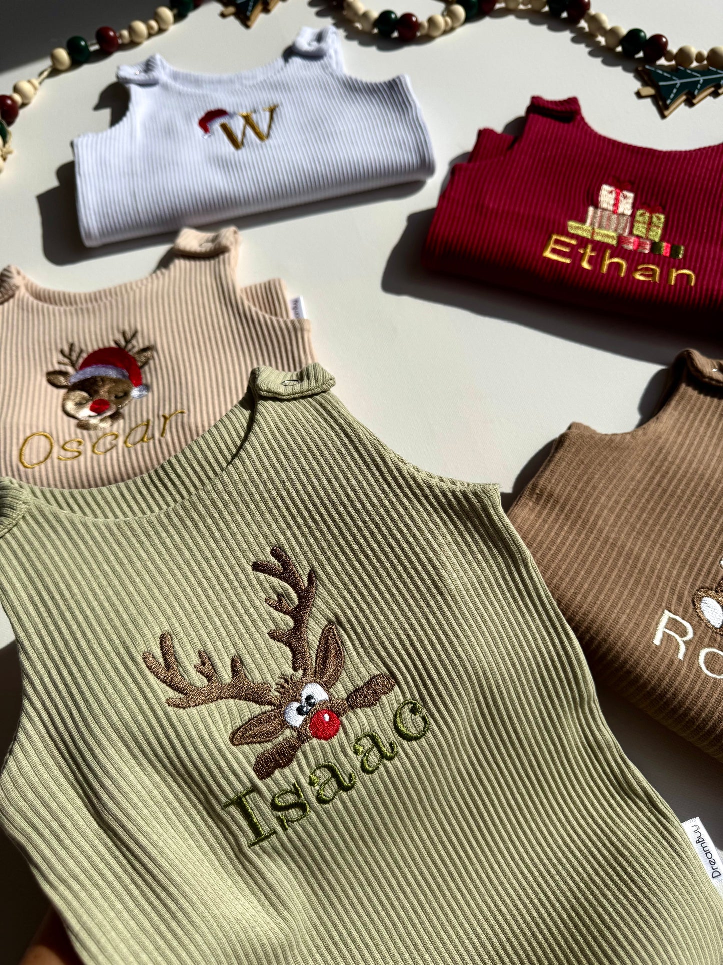 DreamBuy elegant baby dungarees showcasing festive embroidered reindeer, ideal for holiday celebrations.