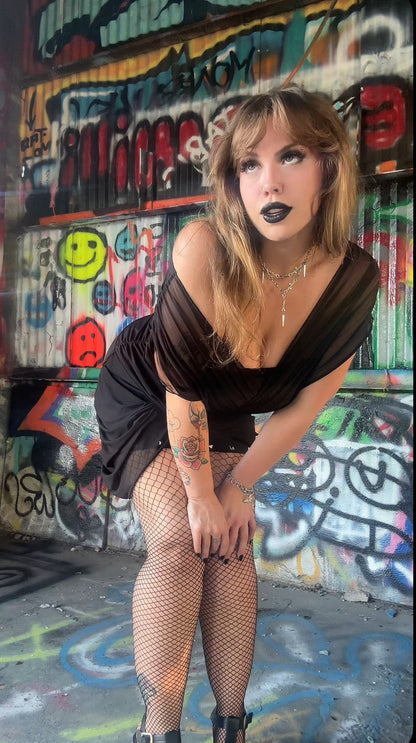 Model elegantly wearing Necessary Evil Venus Wrapped Mesh Mini Dress at an event, capturing the essence of gothic luxury fashion.