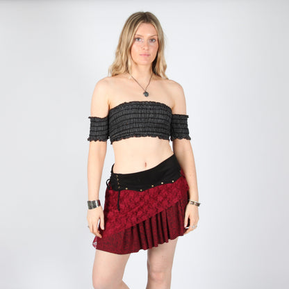 Model wearing the Layered Asymmetric Mini Skirt in deep red, showcasing its flattering fit and layered design, perfect for both casual and formal looks.