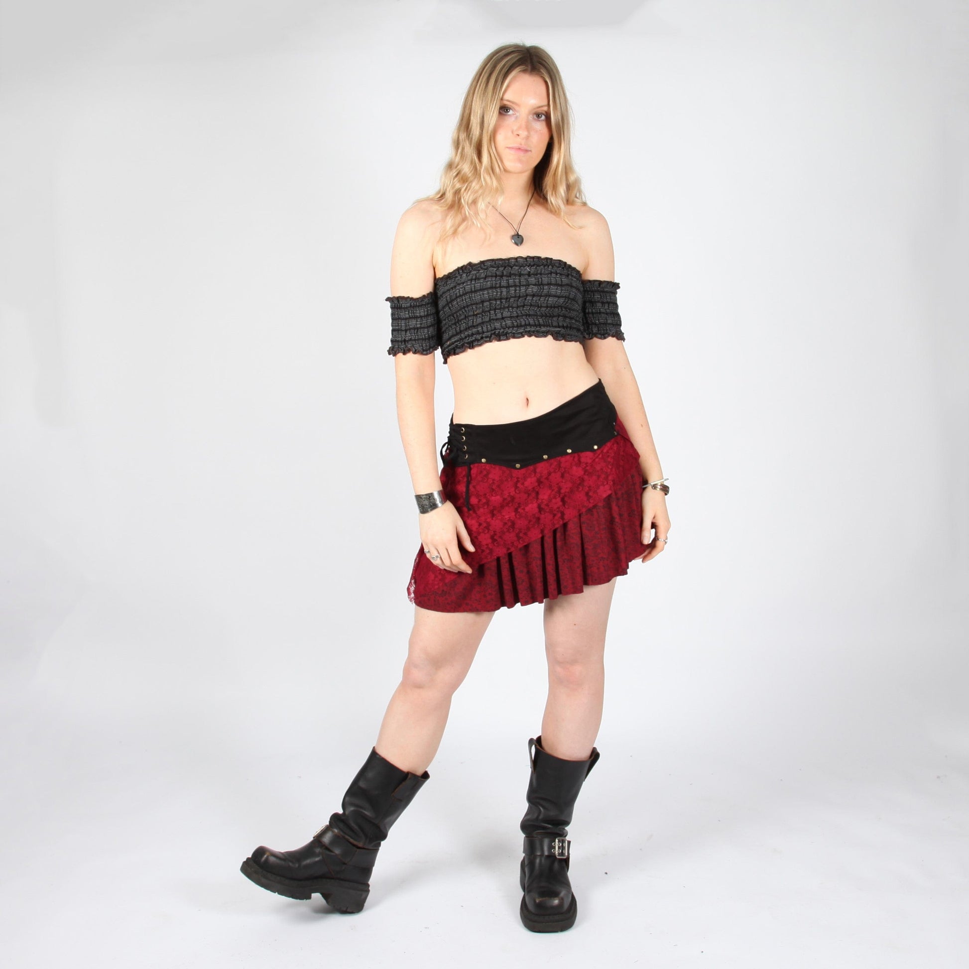 Elegant layered asymmetric mini skirt in deep red with lace detail and faux suede waistband, perfect for stylish occasions.