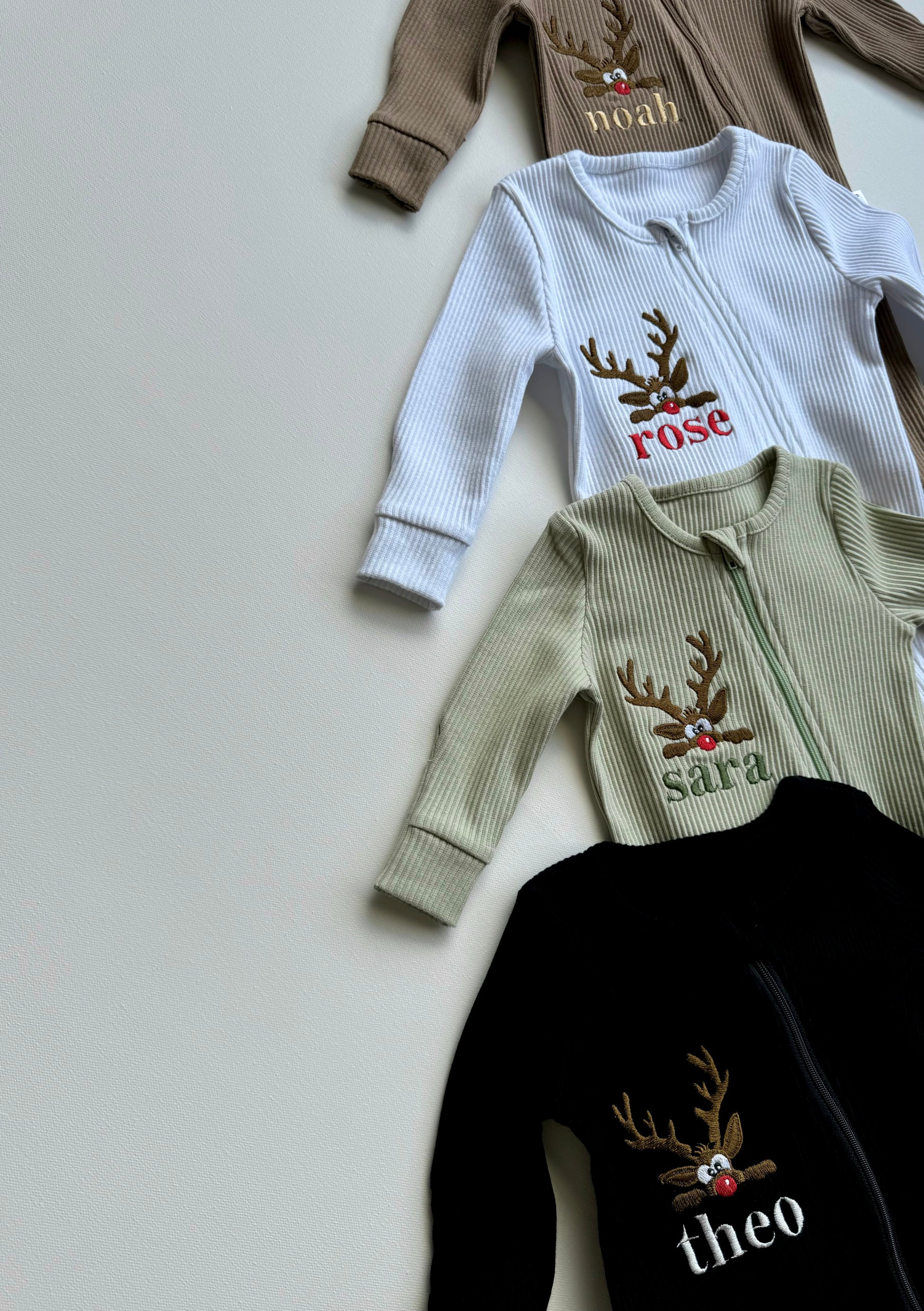 Close-up of the soft ribbed cotton fabric of the DreamBuy Christmas Reindeer Zip Sleepsuit for cozy winter comfort.
