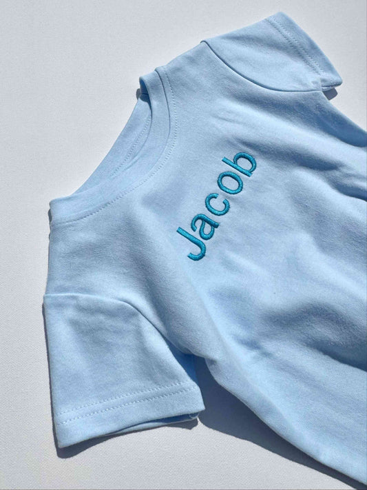 Luxury personalised baby blue soft cotton crewneck t-shirt for kids aged 1-5 years by DreamBuy, perfect for summer outings and embroidered with custom name.