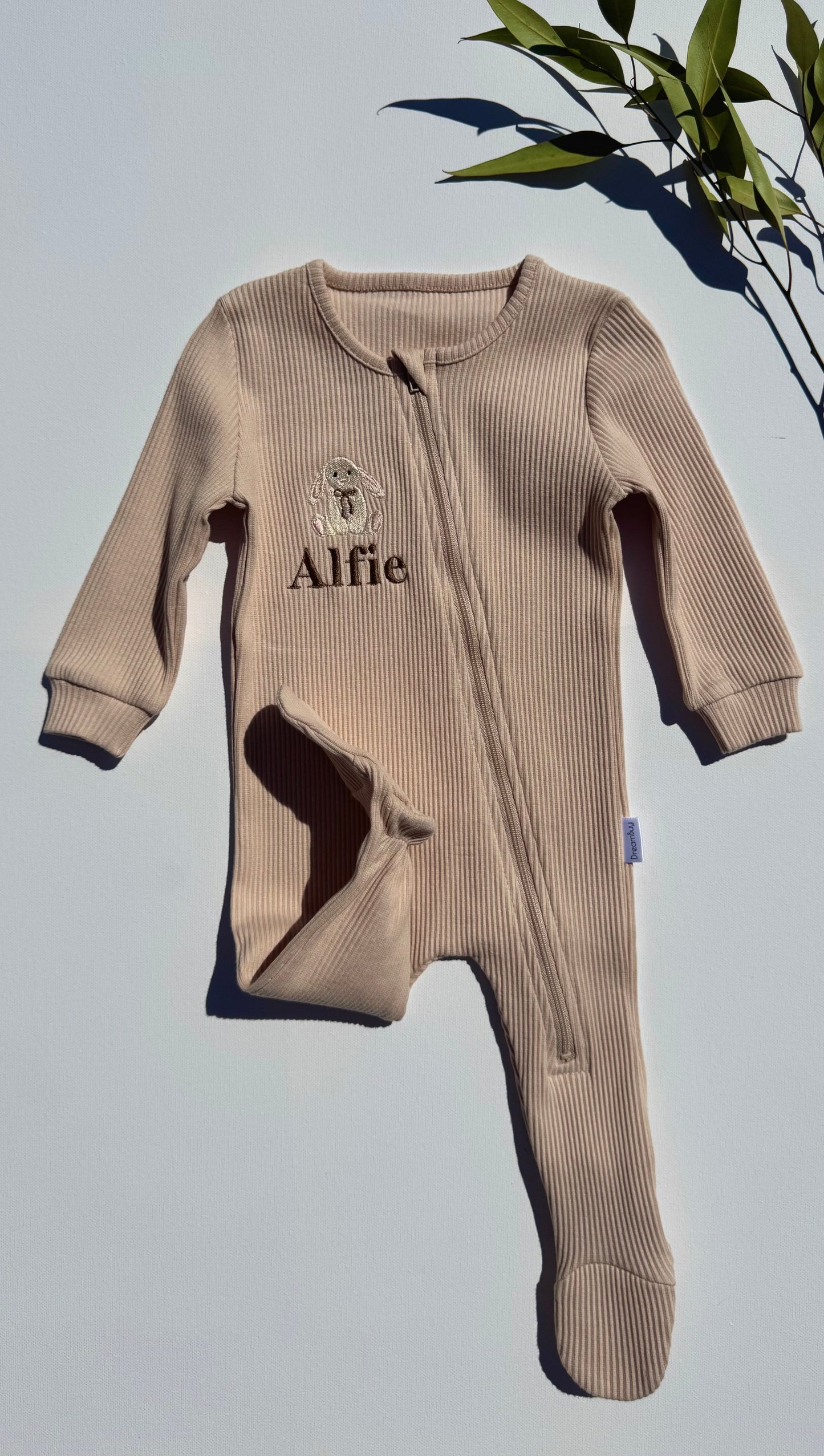 Soft cotton baby zip romper by DreamBuy with custom name embroidery, showcasing delightful safari animals.