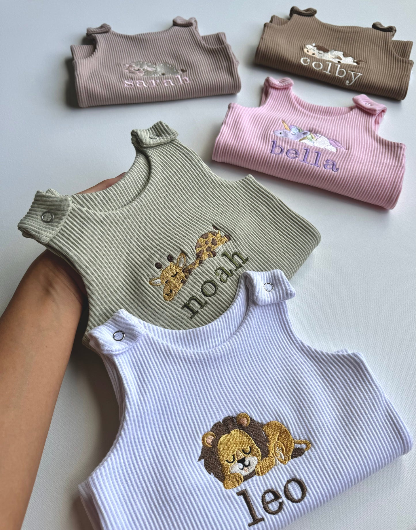 Stylish baby wearing DreamBuy's safari-themed dungarees, highlighting the embroidered jungle animals in an outdoor setting.