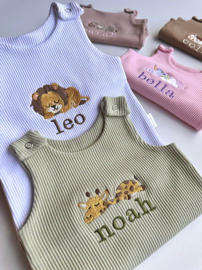 A charming display of DreamBuy's luxury safari dungarees for infants, emphasizing the quality and unique personalization options.