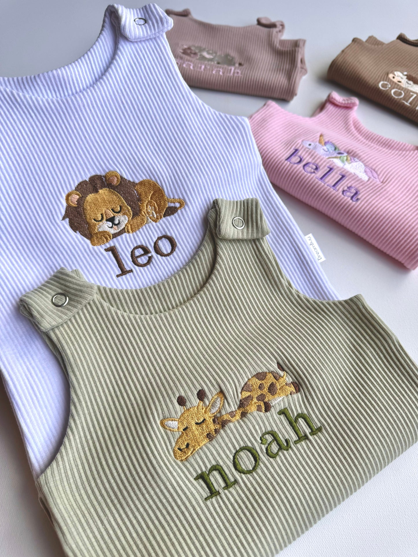 Charming safari animal embroidery showcased on DreamBuy's luxurious dungarees for babies aged 0-3 years.