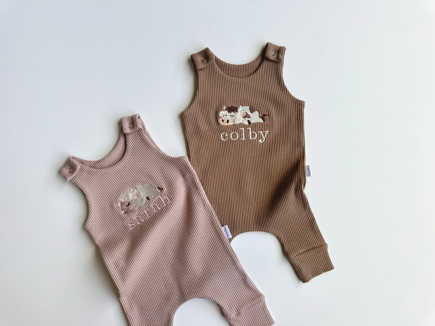 Elegant close-up of DreamBuy's farm theme personalised dungarees showcasing a delightful cow embroidery design.