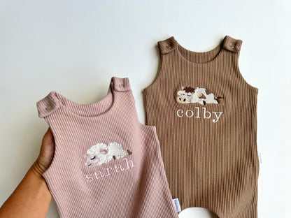 DreamBuy's personalized safari dungarees against a vibrant backdrop, perfect for adding a touch of adventure to your baby's wardrobe.