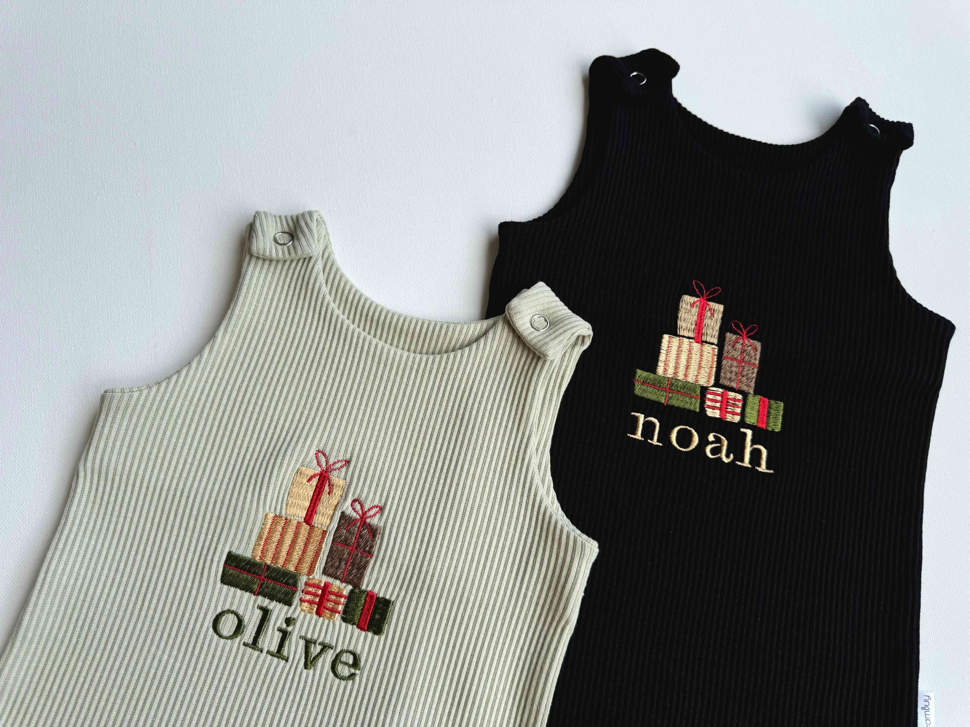 DreamBuy's adorable Christmas dungarees for babies, featuring a festive gift box design, perfect for special holiday moments.