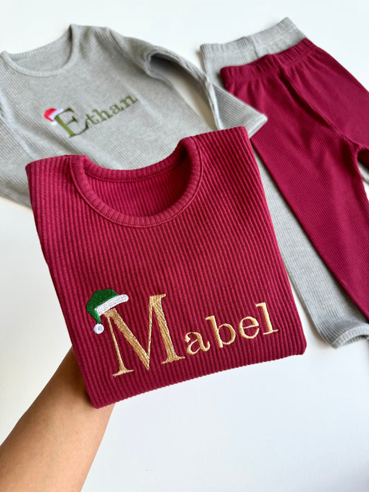 Luxurious personalized Christmas family lounge set by DreamBuy, featuring cozy ribbed pajamas for all ages with festive Santa hat design, ideal for holiday gatherings.