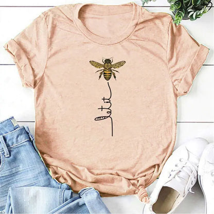 The Bee Kind Women's Graphic Tee by Dazzling Dreams Studio styled with chic summer accessories, illustrating the perfect outfit for casual outings and elegant summer evenings.
