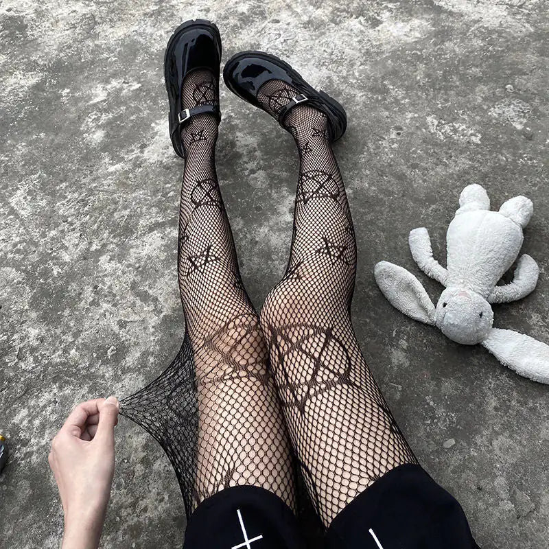 Dazzling Dreams Studio Pentacle Design Fishnet Stockings elegantly displayed while being worn, accompanied by stylish footwear and a plush companion, evoking a luxurious and daring fashion sense.