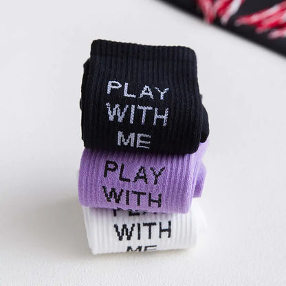 Elegant display of Dazzling Dreams Women's/Girl's Street Sports Socks in a stack, showcasing a variety of colours including black, white, and purple with trendy lettering, ideal for modern streetwear.