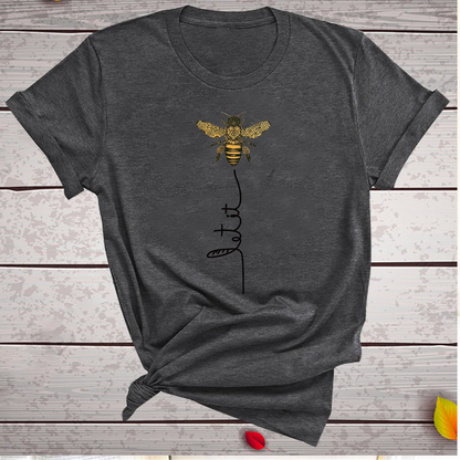 Bee Kind Women's Graphic Tee laid flat, showcasing its soft texture and stylish design elements, perfect for elevating any casual wardrobe by Dazzling Dreams Studio.