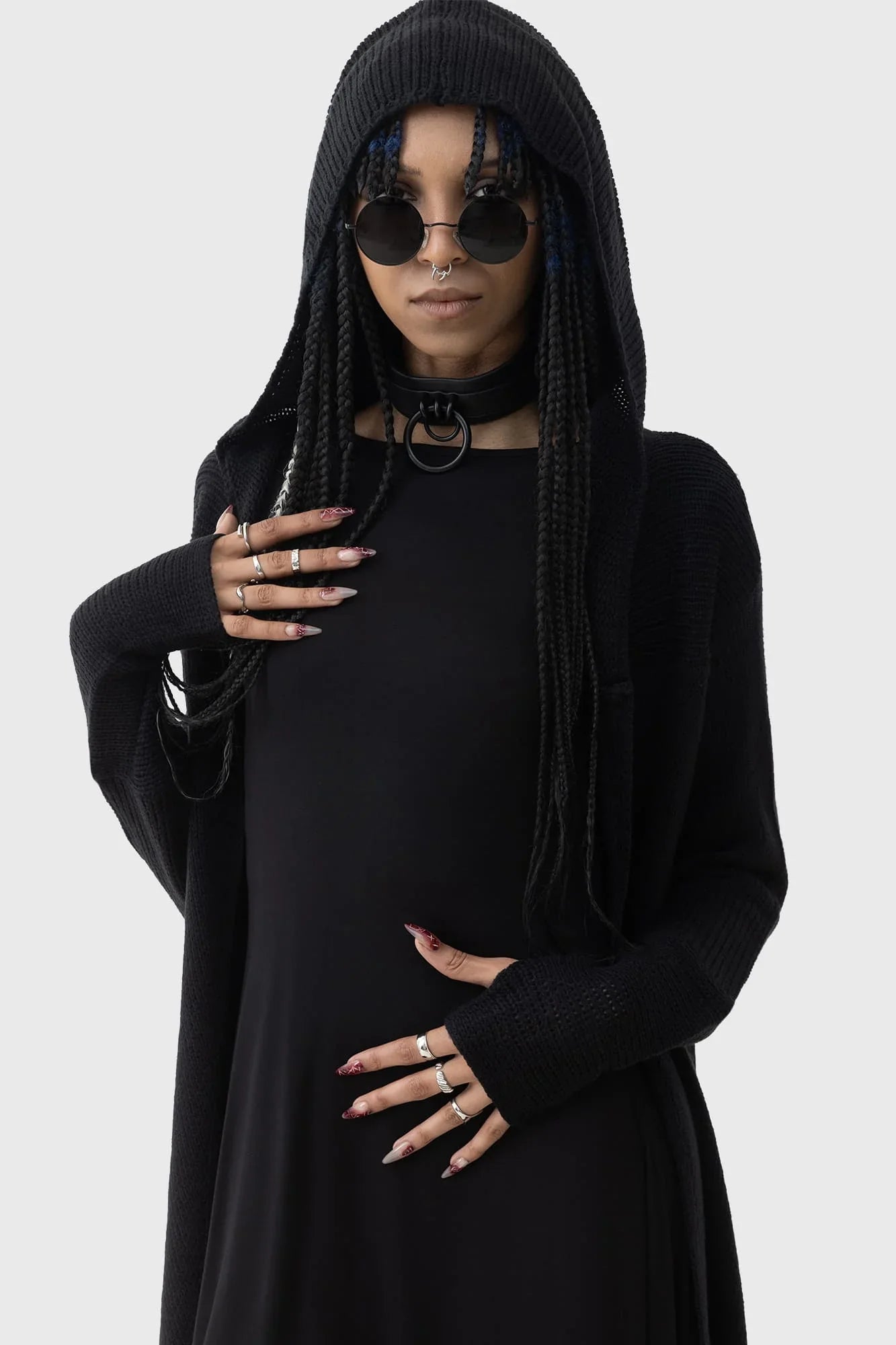 Model wearing the Killstar Last Quarter Hooded Cardigan, exuding a gothic aura with the oversized hood and flowing silhouette, accentuated by dramatic side dips.