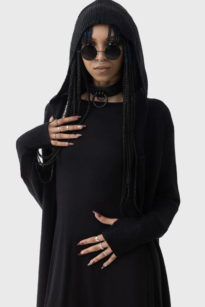 Model wearing the Killstar Last Quarter Hooded Cardigan, exuding a gothic aura with the oversized hood and flowing silhouette, accentuated by dramatic side dips.