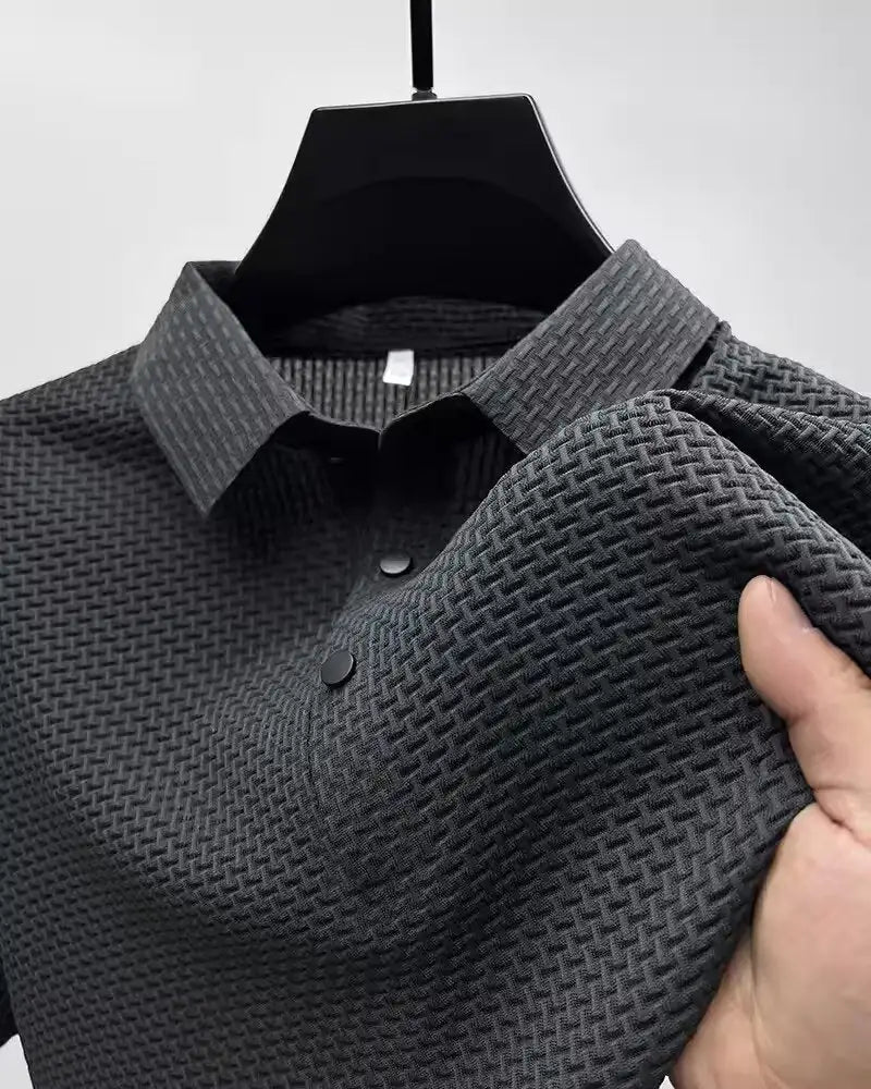 Detail shot of a sophisticated men's polo shirt featuring intricate textured fabric and smart lapel design, perfect for modern elegance.