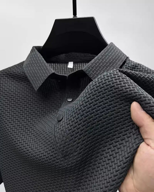 Detail shot of a sophisticated men's polo shirt featuring intricate textured fabric and smart lapel design, perfect for modern elegance.