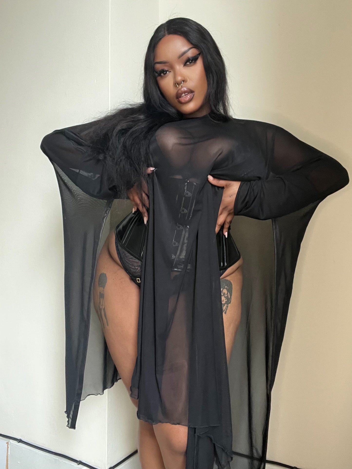 Artful styling of the Necessary Evil Anahita Sheer Dress layered over a slip dress, representing endless fashion possibilities.