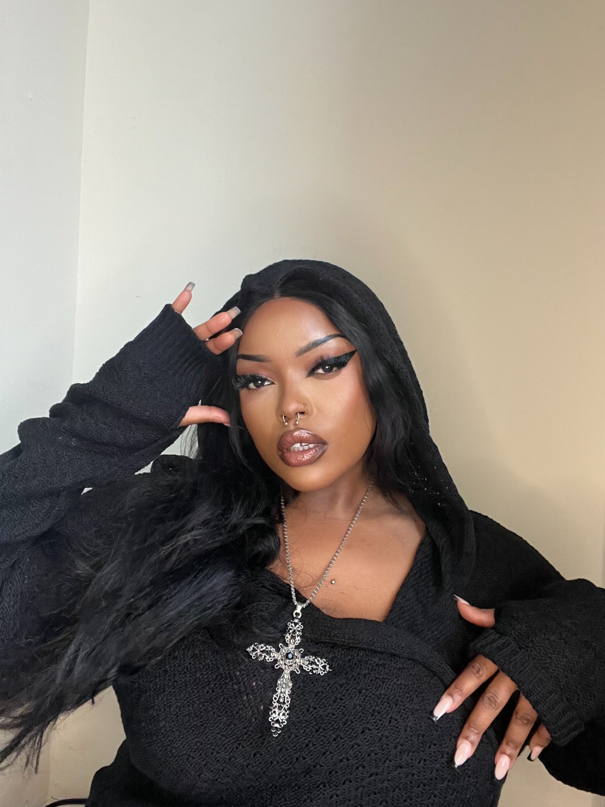 Necessary Evil Athena Long Hooded Cardigan displayed on a model, showcasing its flattering fit and elegant open front design suitable for casual or festival wear.