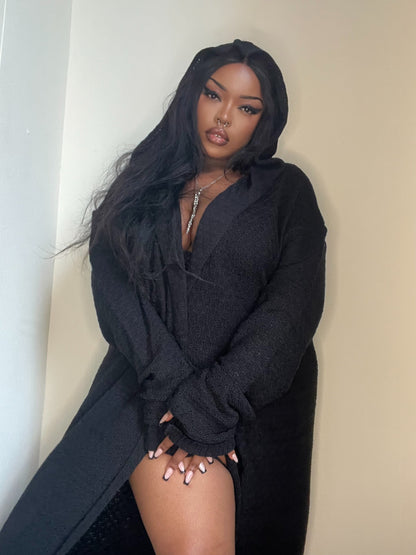 Close-up of Necessary Evil's Athena Cardigan, highlighting the intricate soft knit texture and the generous hood that enhances its gothic allure.