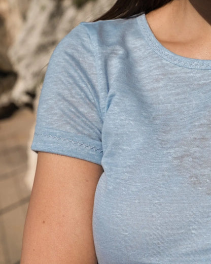 Versatile women's linen t-shirt paired with stylish denim shorts, perfect for a chic summer look.