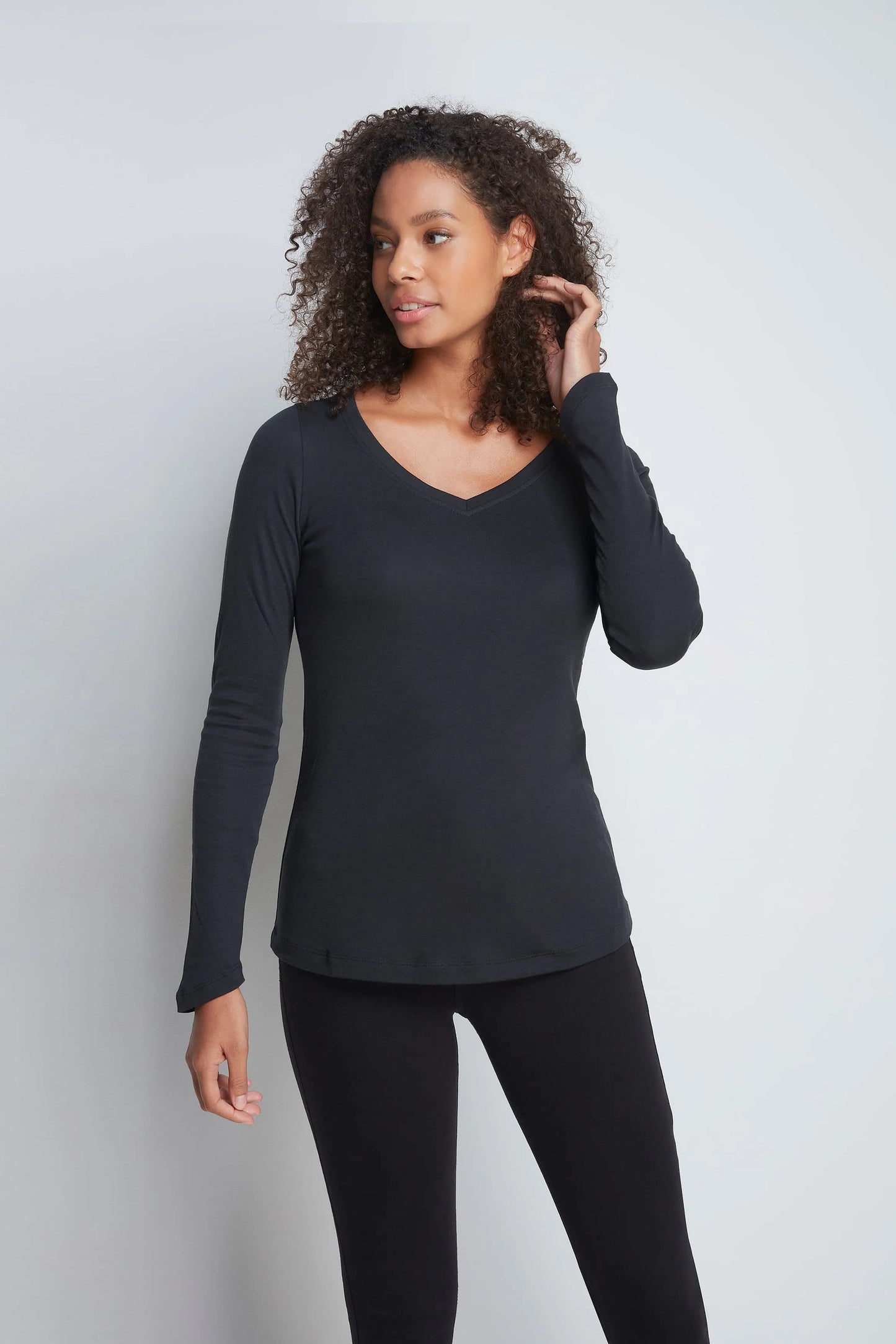 Elegant display of the luxurious women's long sleeve V neck t-shirt, highlighting the chic V neckline and branded hem label for a touch of sophistication.