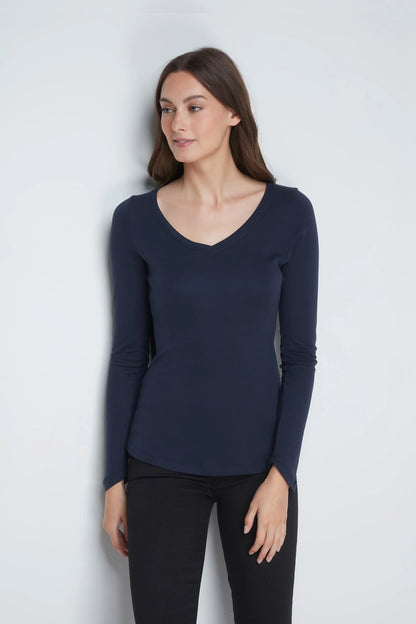 Model wearing the stylish women's long sleeve V neck t-shirt, demonstrating its flattering fit and versatile design in a casual setting.
