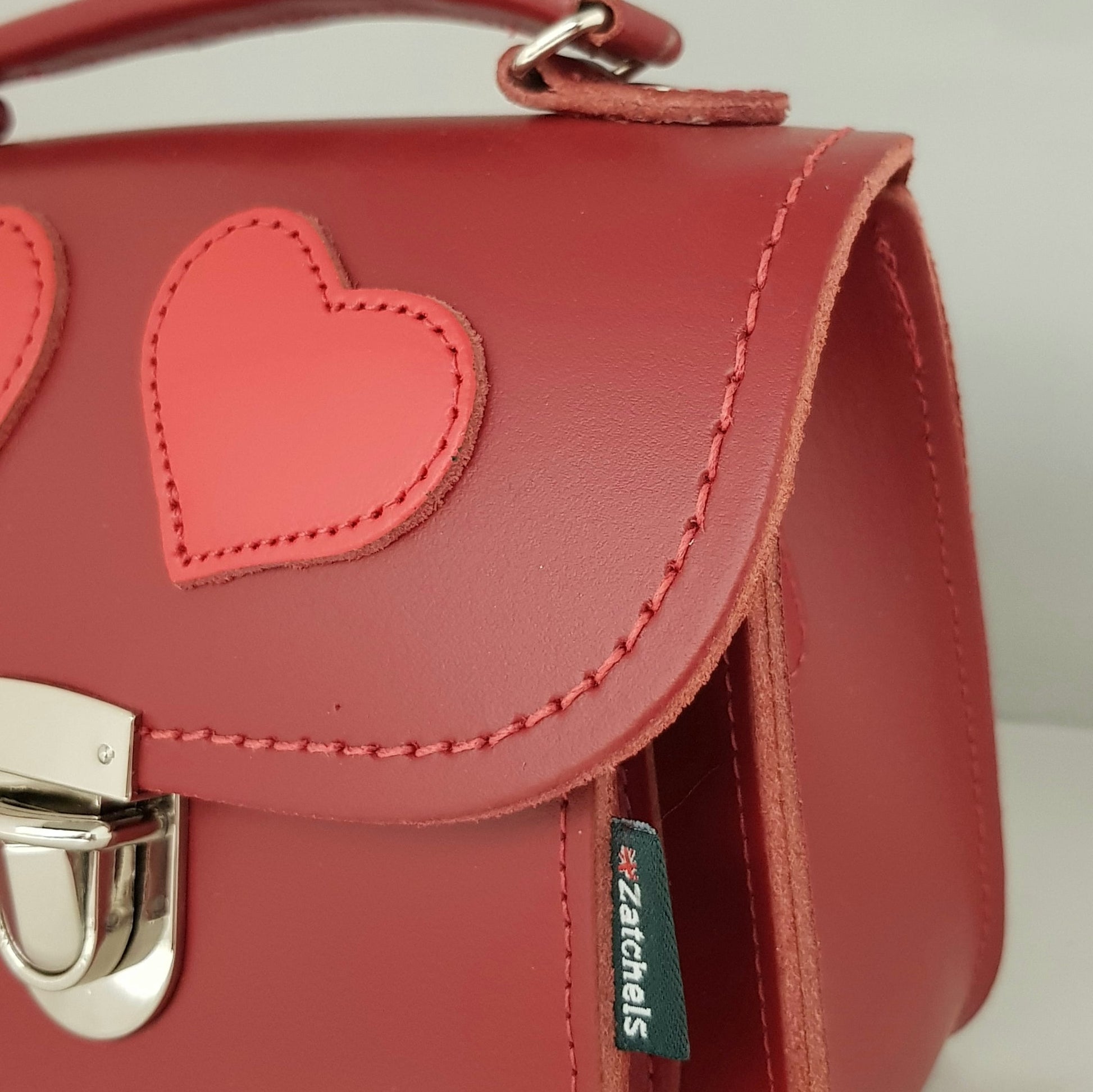 Detail view of the Luna Handmade Leather Crossbody Bag from Zatchels, highlighting the secure push lock clasp and luxurious UK-produced leather finish.