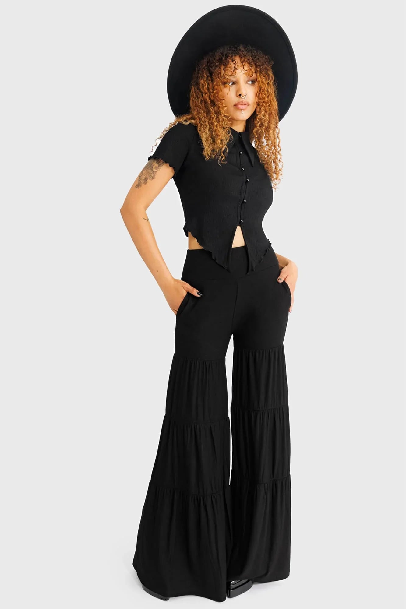 Killstar Maleficum tiered wide-leg trousers elegantly draped in soft stretch fabric, showcasing gothic style and functional pockets, ideal for a luxurious wardrobe.