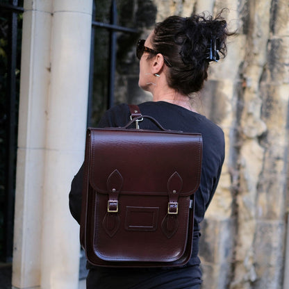 Luxury Handmade Leather City Backpack in Marsala Red, showcasing high-quality Scottish leather, designed for tablets and laptops up to 13 inches, featuring silver nickel buckles and a sophisticated design suitable for modern urban explorers.
