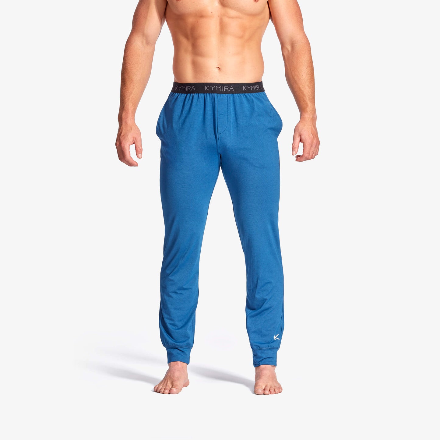 Men's Infrared Recovery Sleepwear Bottoms by KYMIRA made from luxurious soft jersey fabric, designed for superior comfort and breathability. Available in sizes XS to XXL, these sleepwear bottoms feature a stylish jogger fit, elasticated waist, side seam pockets, and advanced infrared technology for increased circulation and recovery.