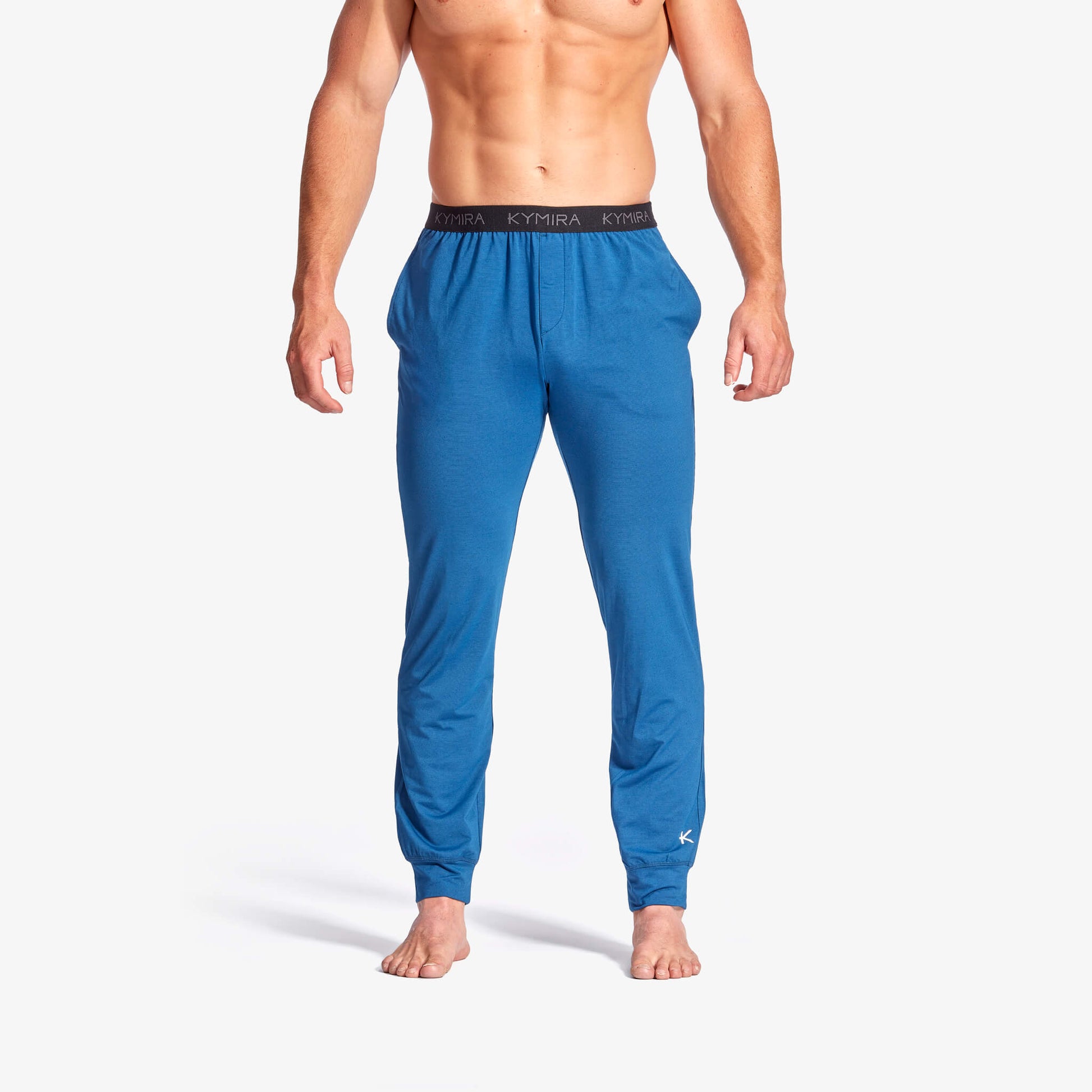 Men's Infrared Recovery Sleepwear Bottoms by KYMIRA made from luxurious soft jersey fabric, designed for superior comfort and breathability. Available in sizes XS to XXL, these sleepwear bottoms feature a stylish jogger fit, elasticated waist, side seam pockets, and advanced infrared technology for increased circulation and recovery.