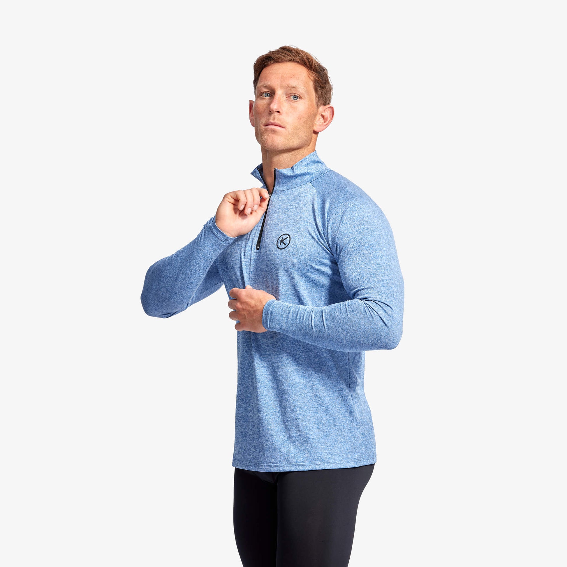 KYMIRA Men's Infrared 1/4 Zip Long Sleeve Top on a model, illustrating its sleek cut and functional 1/4 zip ideal for layering during sports activities.