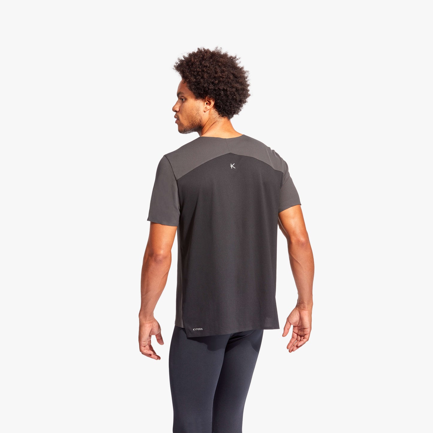 Elegant display of KYMIRA men's Charge performance t-shirt, highlighting the elongated back for enhanced fit and functionality.