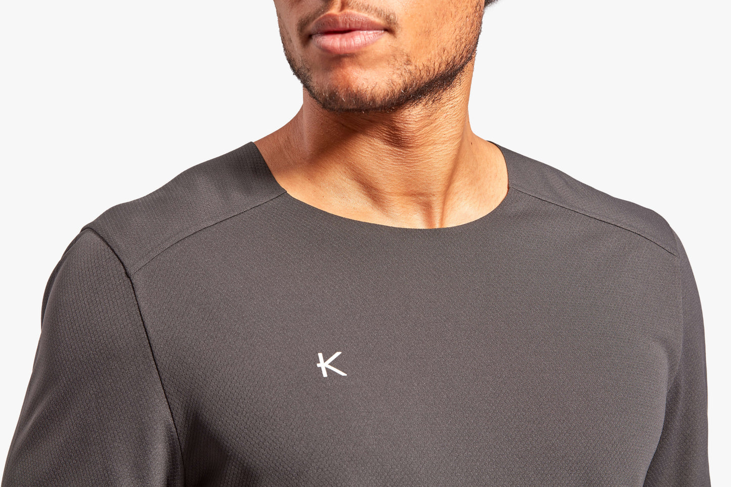 Dynamic shot of the men's KYMIRA Charge infrared t-shirt, illustrating its versatility for intense training and outdoor activities.