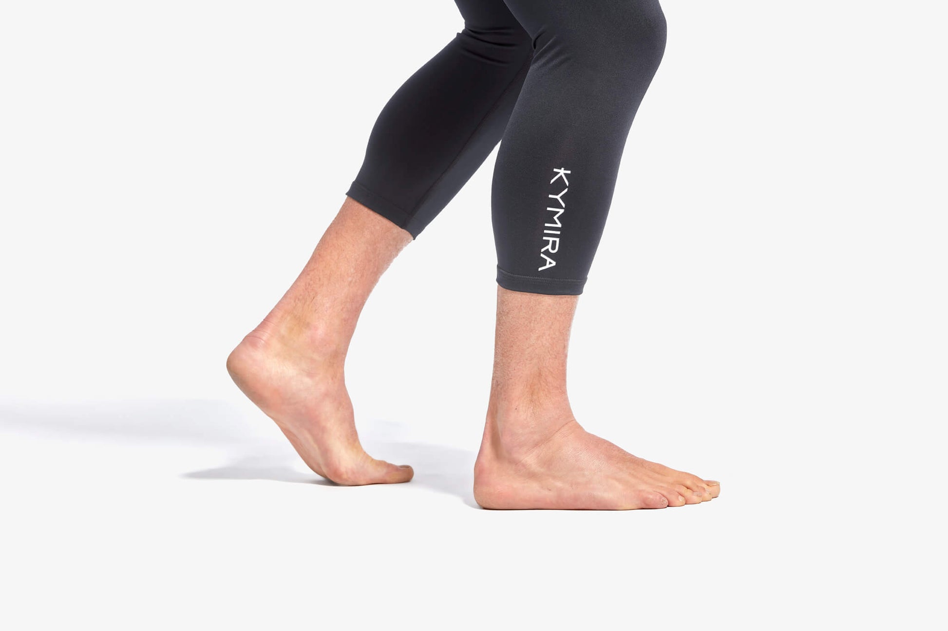 Lifestyle image of KYMIRA Men's Infrared Performance Leggings paired with infrared compression socks, illustrating a refined athletic look and optimal recovery benefits.