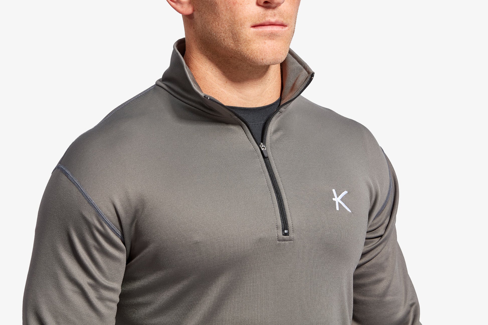 Dynamic model wearing the KYMIRA Infrared Infracycle™ Half Zip Fleece, capturing the essence of sport and luxury.