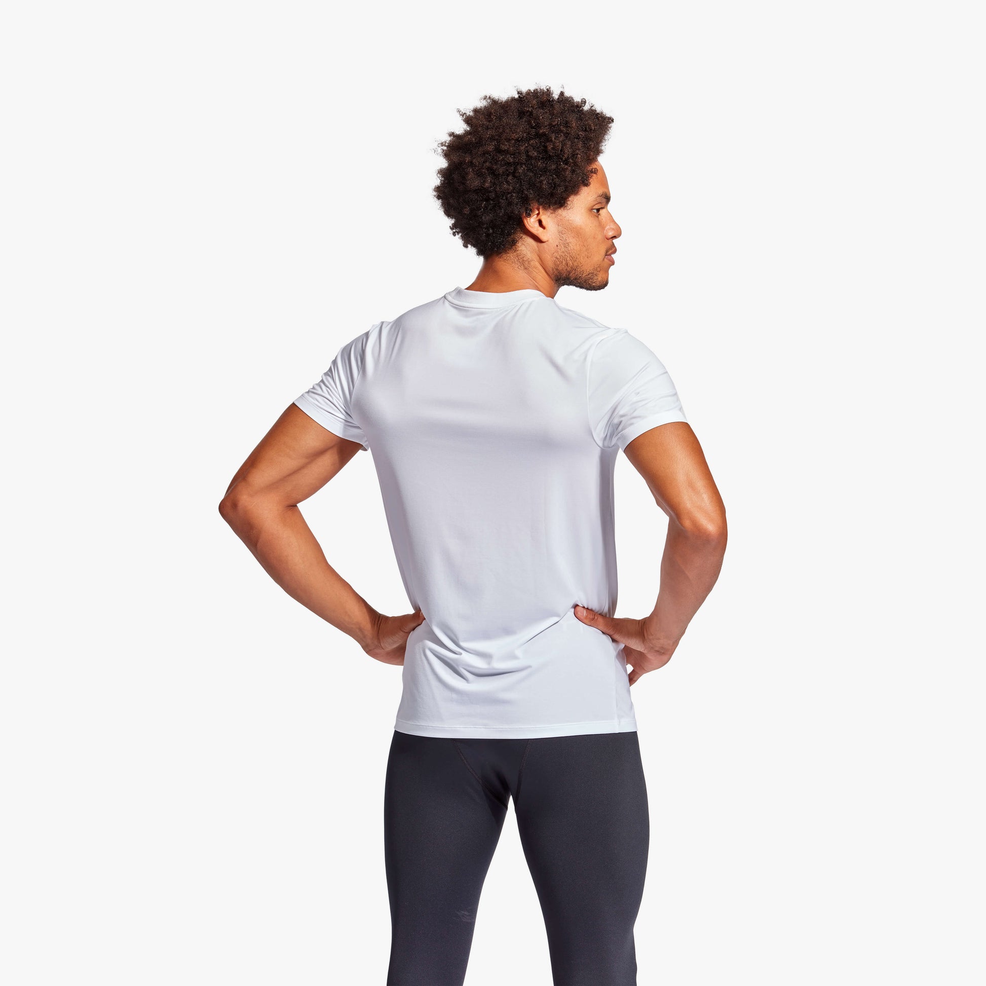 KYMIRA Men's Infrared Recovery T-Shirt worn by an athlete, demonstrating its stylish fit and advanced recovery technology in a luxury athletic setting.
