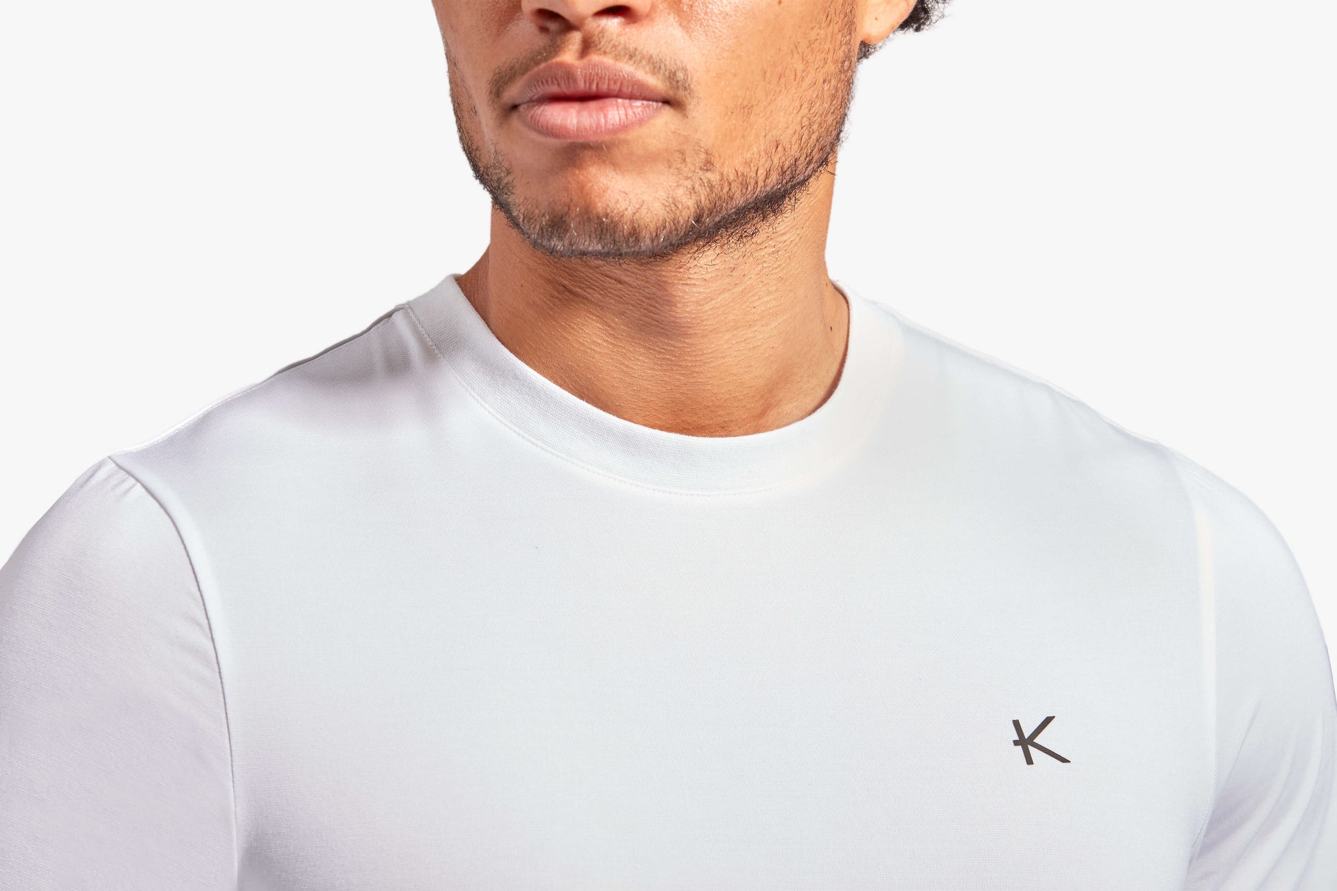 KYMIRA Men's Infrared Recovery T-Shirt displayed on a classic marble surface, emphasising its elegant design and functional fabric ideal for luxury sports enthusiasts.