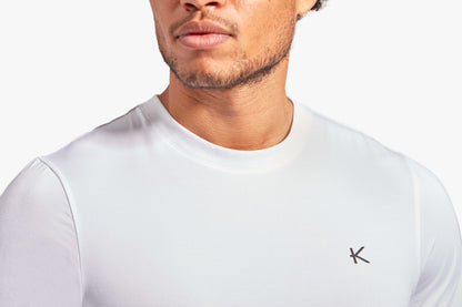 KYMIRA Men's Infrared Recovery T-Shirt displayed on a classic marble surface, emphasising its elegant design and functional fabric ideal for luxury sports enthusiasts.