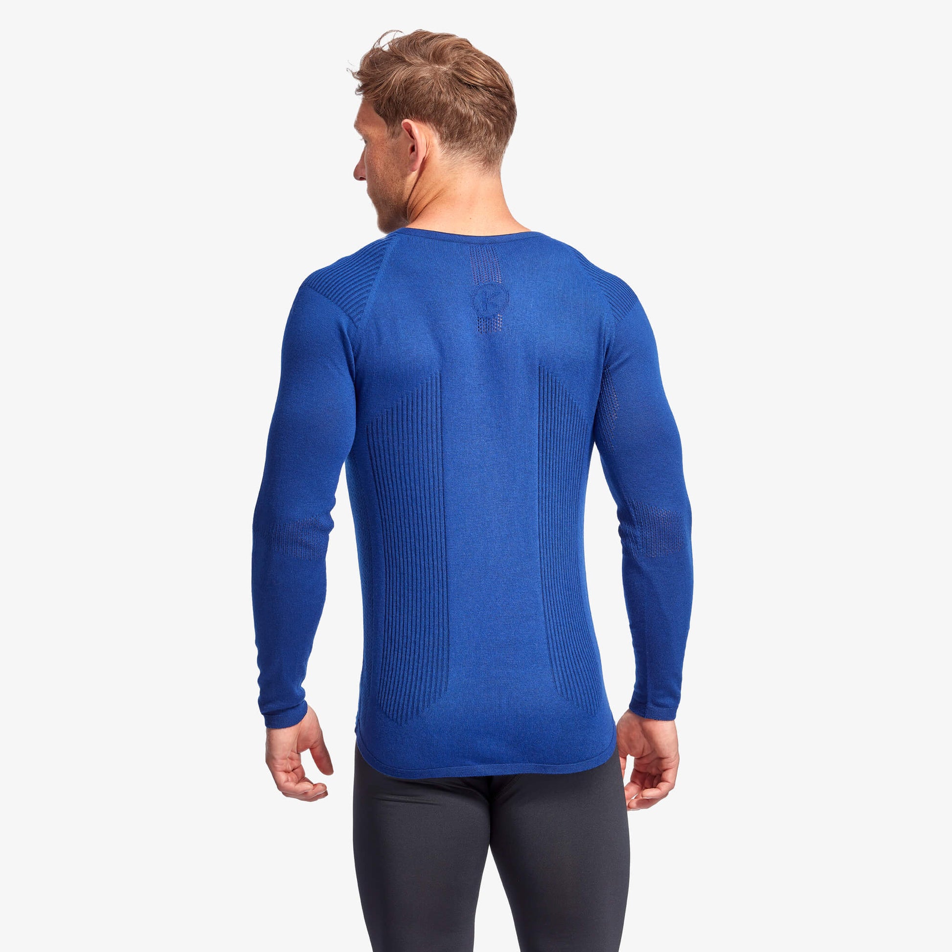 Stylish image of the Men's KYMIRA Infrared Merino Wool Baselayer Top, focusing on its versatile design suitable for layering, in premium sustainable merino wool.