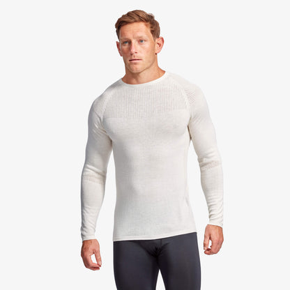 Model wearing KYMIRA Men's Infrared Merino Wool Baselayer Top in a fitness setting, demonstrating its performance-enhancing features and sleek silhouette.