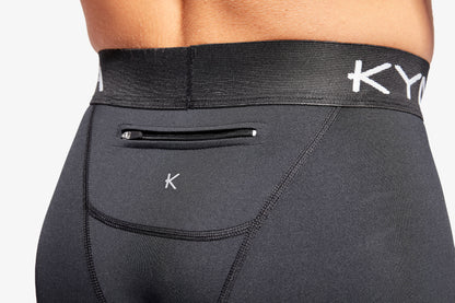 Detail of KYMIRA Men's Core Infrared Leggings highlighting the elastic waistband and zip pocket, designed for convenience and a secure fit.