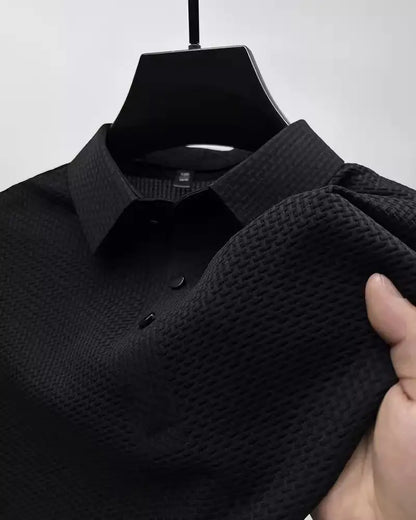 Chic black men's polo shirt with textured finish and classic lapel design, offering a blend of comfort and sophistication for the discerning gentleman.