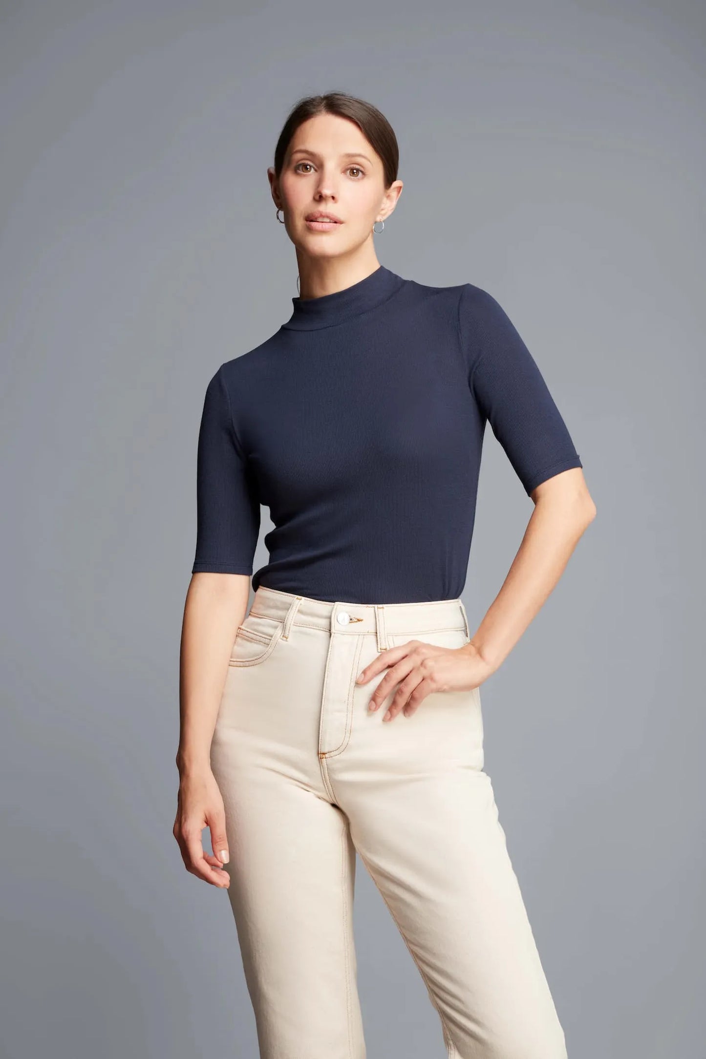 Elegant women's Mock Neck Micro Modal Top displayed against a stylish backdrop, perfect for layering and transitioning from day to night.