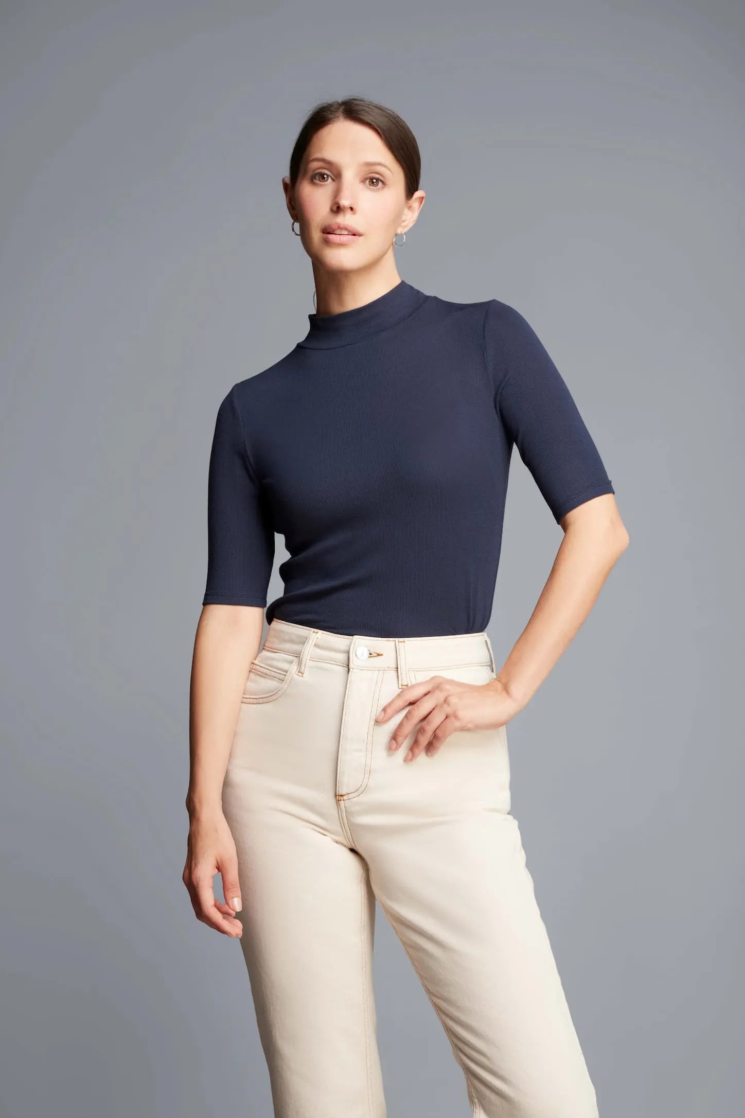 Elegant women's Mock Neck Micro Modal Top displayed against a stylish backdrop, perfect for layering and transitioning from day to night.